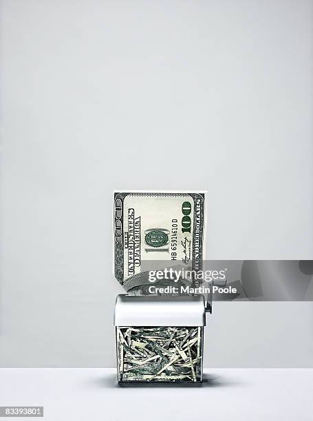 large 100 dollar bill going into shredder - paper shredder money stock pictures, royalty-free photos & images