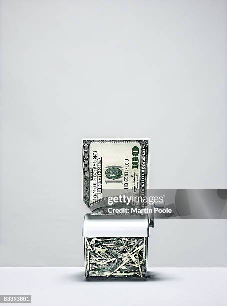 large 100 dollar bill going into shredder - wasting money stock pictures, royalty-free photos & images