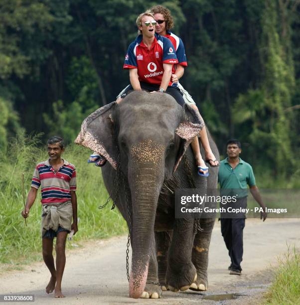 England's Graeme Swann and Ryan Sidebottom ride an elephant during a visit to Pinawella village near Kandy, Sri Lanka.