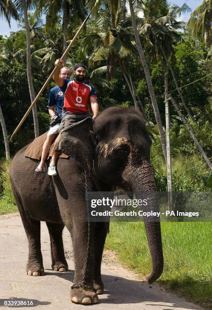 England's Monty Panesar and coach Mark Saxby ride an elephant during a visit to Pinawella village near Kandy, Sri Lanka.