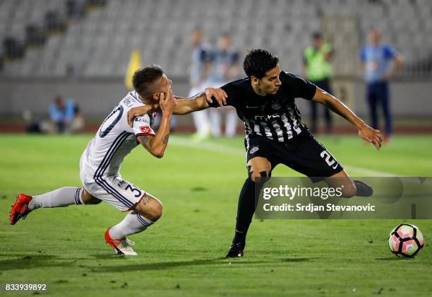 Marko Jevtovic of Partizan in action against Roland Szolnoki of Videoton during the UEFA Europa League Qualifying Play-Offs round first leg match...