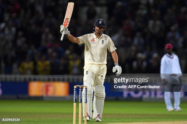 England's Alastair Cook celebrates reaching 150, under lights on the first day of the first Test cricket match between England and the West Indies at...