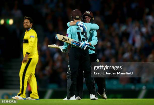 Scott Borthwick and Gareth Batty of Surrey celebrate their victory during the NatWest T20 Blast match between Surrey and Gloucestershire at The Kia...