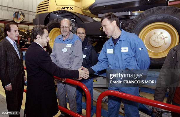 France's President Nicolas Sarkozy meets workers during a visit of Mecalac Ahlmann factory that builds mechanical digger on October 23, 2008 in...
