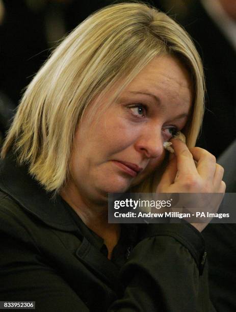 Sharon Brown, Vicky Hamilton's sister wipes away tears during Vicky's funeral service at Redding Parish Church.