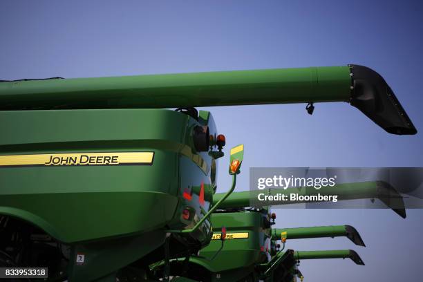 Deere & Co. John Deere combine harvesters sit on display for sale at the Smith Implements Inc. Dealership in Greensburg, Indiana, U.S., on Wednesday,...