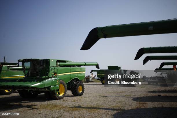 Deere & Co. John Deere combine harvesters sit parked at the Smith Implements Inc. Dealership in Greensburg, Indiana, U.S., on Wednesday, Aug. 16,...