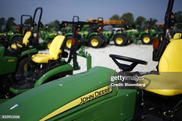 Deere & Co. John Deere signage is displayed on a riding mover at the Smith Implements Inc. Dealership in Greensburg, Indiana, U.S., on Wednesday,...