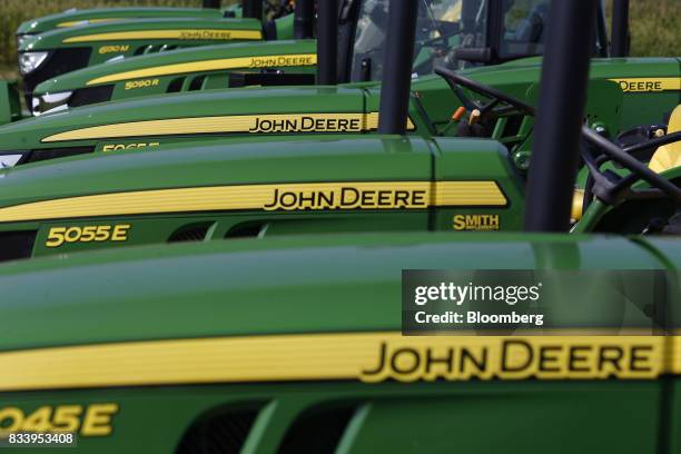 Deere & Co. John Deere tractors sit on display for sale at the Smith Implements Inc. Dealership in Greensburg, Indiana, U.S., on Wednesday, Aug. 16,...