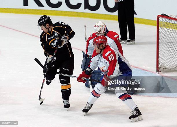 Kuusela Kristian of Kaerpaet Oulu battles for the puck with Seluyanov Alexander and Proskuryakov IIya of Metallurg Magnitogorsk during the IIHF...