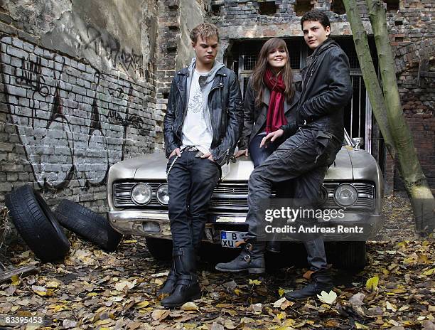 Actor Wilson Gonzalez Ochsenknecht, actress Emilia Schuele and actor Jimi Blue Ochsenknecht pose in front of a car during a photocall to the movie...