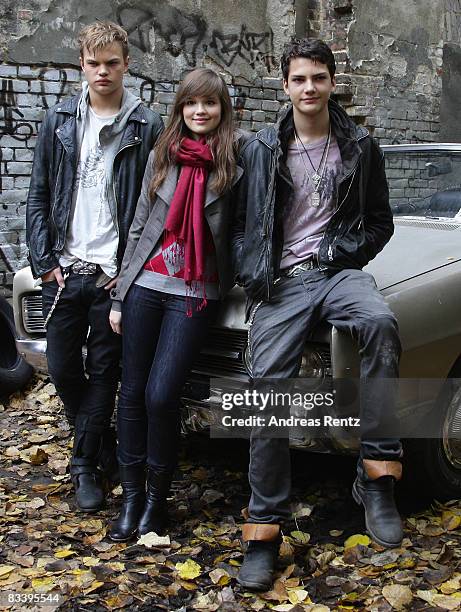 Actor Wilson Gonzalez Ochsenknecht, actress Emilia Schuele and actor Jimi Blue Ochsenknecht pose in front of a car during a photocall to the movie...