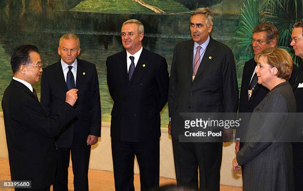 German Chancellor Angela Merkel and Chinese Premier Wen Jiabao talk to German entrepreneur's at the Great Hall of the People on October 23, 2008 in...
