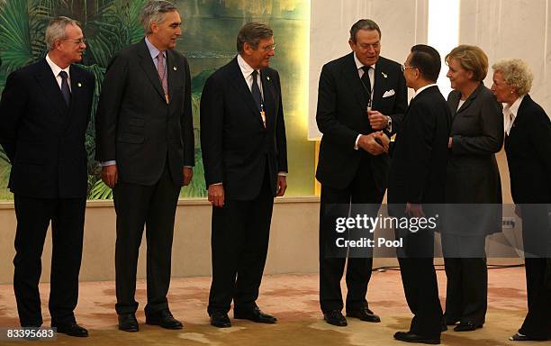 German Chancellor Angela Merkel and Chinese Premier Wen Jiabao shake hands with German entrepreneur's at the Great Hall of the People on October 23,...