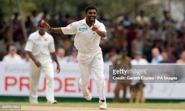 Sri Lanka's Muttiah Muralitharan celebrates dismissing England's Ravi Bopara and taking a record equaling 708 test wickets during the First Test at...