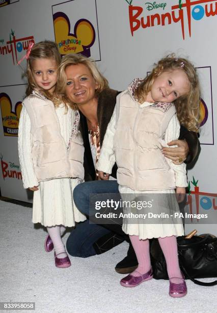 Alice Beer and daughters arrive on the white carpet for Playhouse Disney's Bunnytown Christmas Winter Wonderland party in central London.