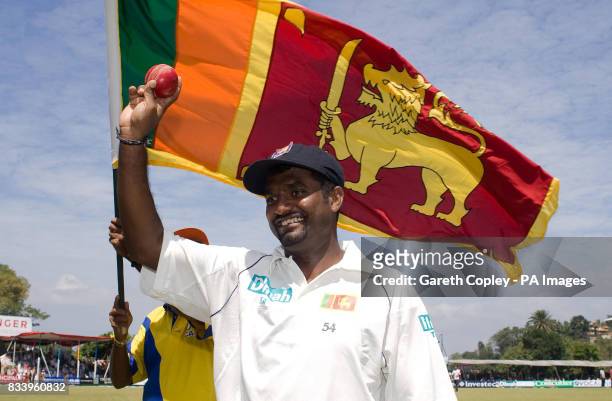 Sri Lanka's Muttiah Muralitharan leaves the field after becoming Test cricket's leading wicket-taker with 710 wickets during the first Test match at...