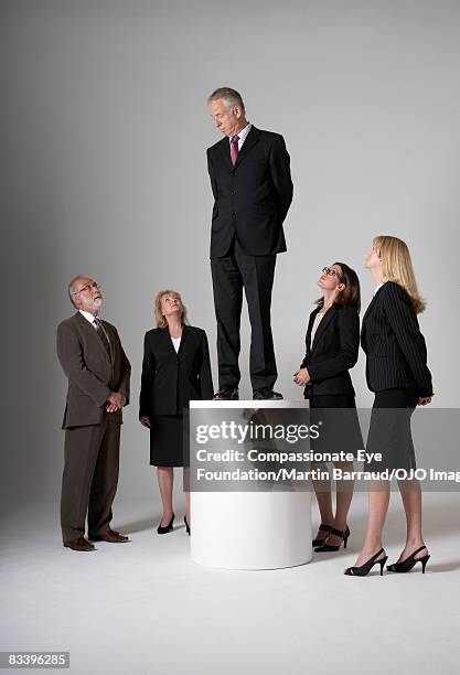 man elevated, looking down on a group of people - vantarsi foto e immagini stock