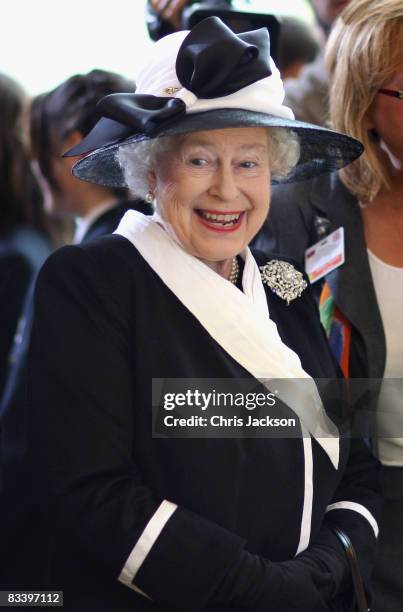 Queen Elizabeth II laughs as she watches children play a game at Devlin Castle Hotel on the first day of a tour of Slovakia on October 23, 2008 in...