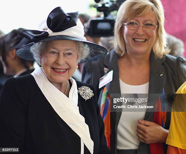 Queen Elizabeth II laughs as she watches children play in a British Council project 'Dreams and Teams' at Devlin Castle Hotel on the first day of a...