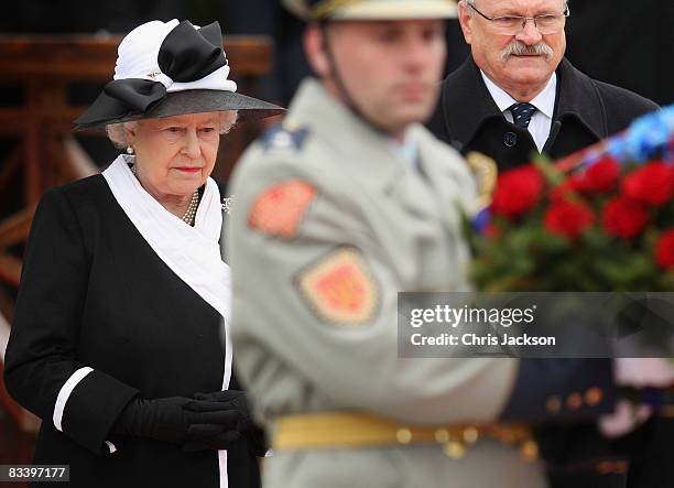 Queen Elizabeth II and President Ivan Gasparovic take part in a wreath laying at Devlin Castle on the first day of a tour of Slovakia on October 23,...