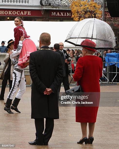 Queen Elizabeth II watches traditional dancing she takes part in a walk about in the Main Square on the first day of a tour of Slovakia on October...