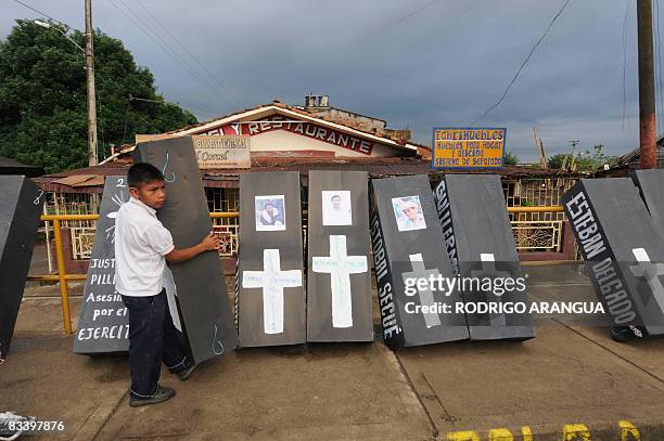 Colombian indigenous boy carries a symbolic coffin during a march along the Pan American highway in Villarrica, in Valle del Cauca department, on...
