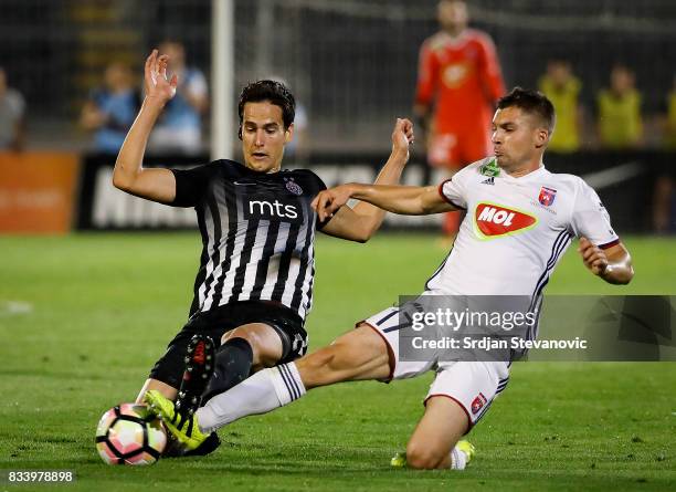 Mate Patkai of Videoton competes for the ball against Marko Jevtovic of Partizan during the UEFA Europa League Qualifying Play-Offs round first leg...