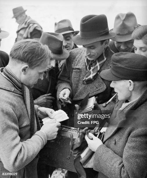 Watch changing hands for cash on the black market in the grounds of a school in Germany circa 1950.