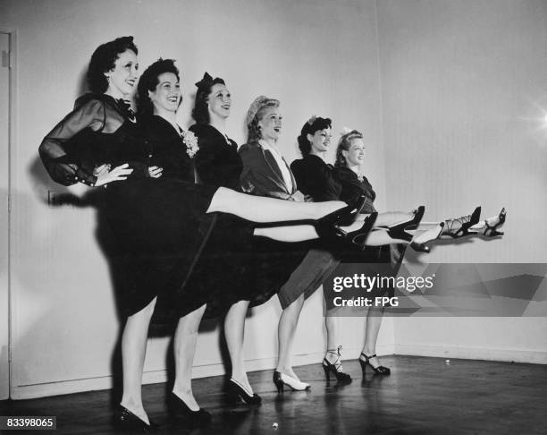 Members of the Radio City Rockettes modelling Legstick, make up to replicate stockings designed to combat wartime shortages, circa 1942. From left to...