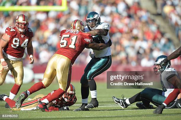 Running back Correll Buckhalter of the Philadelphia Eagles gets hit by linebacker Takeo Spikes of the San Francisco 49ers on October 12, 2008 at...