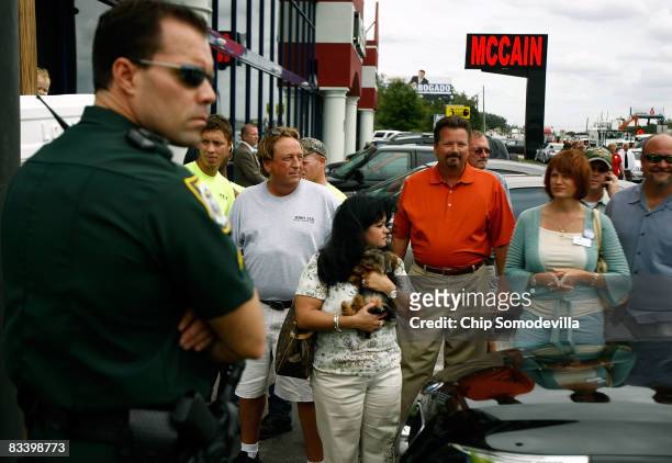 People gather in the parking lot next to Mi Viejo San Juan Restaurant while Republican presidential nominee Sen. John McCain has lunch inside with...