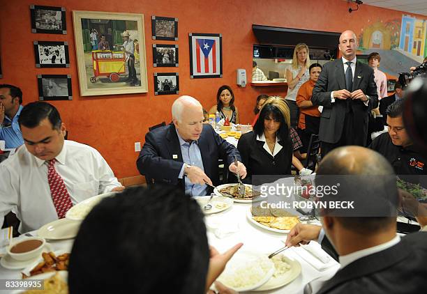 Republican presidential candidate Arizona Sen. John McCain has lunch with Hispanic small business owners at Mi Viejo San Juan restaurant in Orlando,...