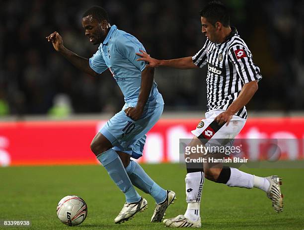 Darren Bent of Tottenham shields the ball from Mauricio Isla of Udinese during the UEFA Cup Group D match between Udinese and Tottenham Hotspur at...