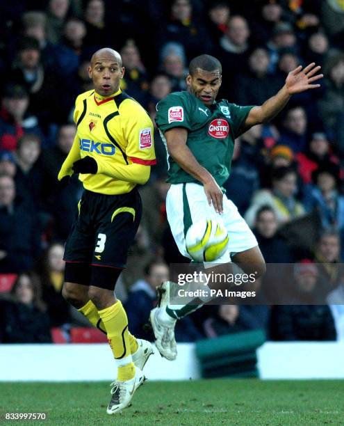 Watford's Marlon King and Plymouth's Jermaine Easter in a challenge during the Coca-Cola Championship match at Vicarage Road, Watford.