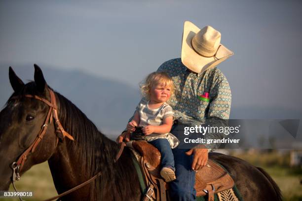 cowboy-vater und zwei jahre altes mädchen - 2 year old blonde girl father stock-fotos und bilder