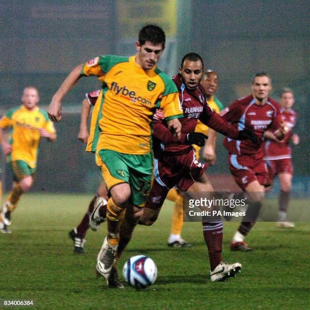 Norwich's Ched Evans and Scunthorpe's Marcus Williams battle for the ball during the Coca-Cola Football League Championship match at Glanford Park,...