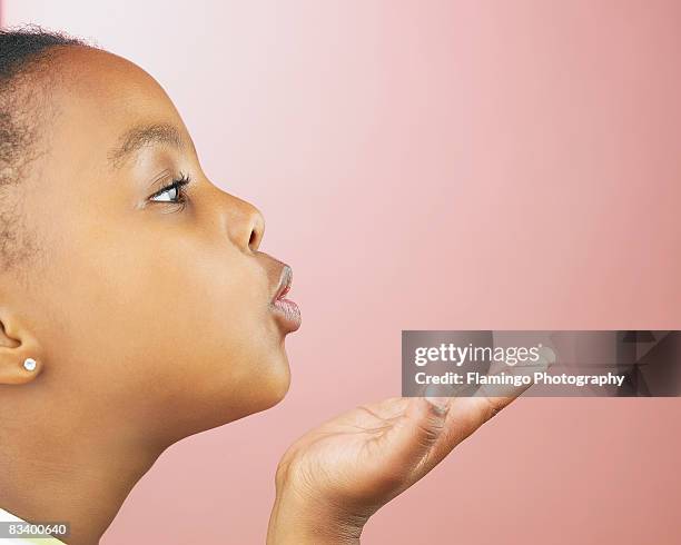 profile of young girl blowing a kiss - endast en flicka bildbanksfoton och bilder