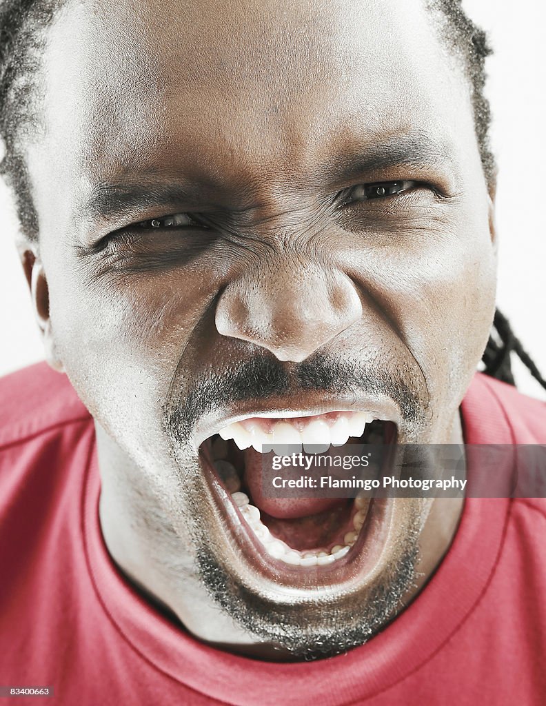 Close up of man shouting with mouth open