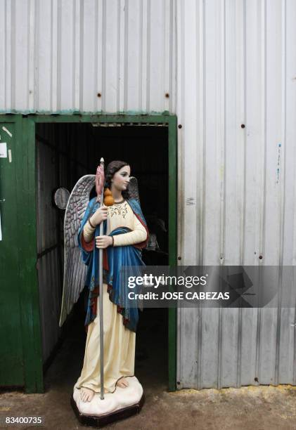 The image of Saint Raphael Archangel awaits for the beginning of a procession outside a dock's office at the port of La Libertad, 35 km south of San...