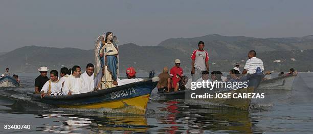 Fishermen navigate in procession in homage to Saint Raphael Archangel at the port of La Libertad, 35 km south of San Salvador, on October 23, 2008....