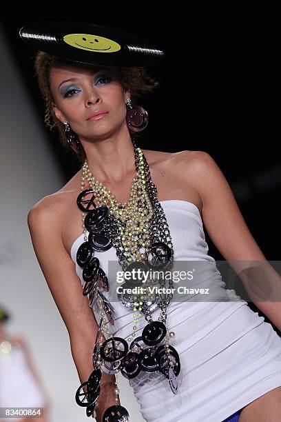 Model walks the runway wearing Gustavo Helguera jewelry and accessories Spring/Summer 2009 during Fashion Week Mexico at Campo Marte on October 22,...
