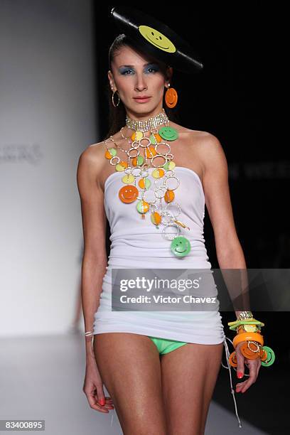 Model walks the runway wearing Gustavo Helguera jewelry and accessories Spring/Summer 2009 during Fashion Week Mexico at Campo Marte on October 22,...