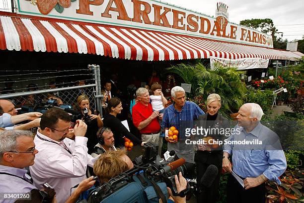 Republican presidential nominee Sen. John McCain speaks to the the news media with his wife Cindy McCain, Florida Governor Charlie Crist and...