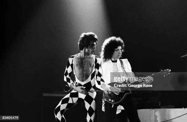 Singer Freddie Mercury and guitarist Brian May of the rock group Queen perform "We Are The Champions" onstage during a 1978 Inglewood, California,...