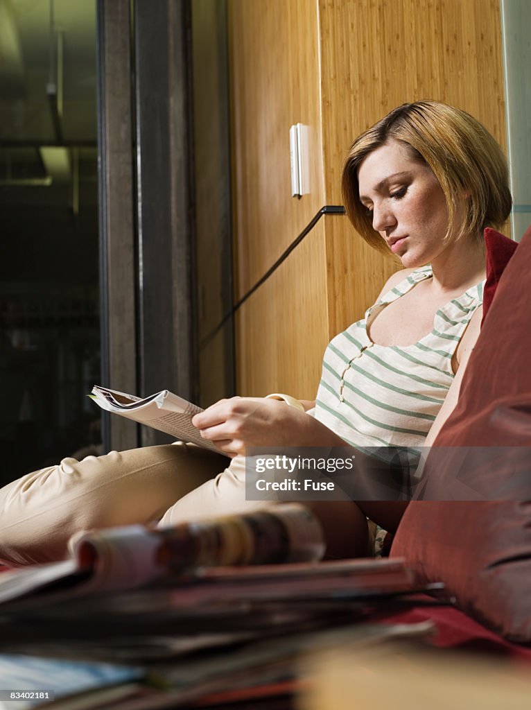 Young Woman Reading a Magazine