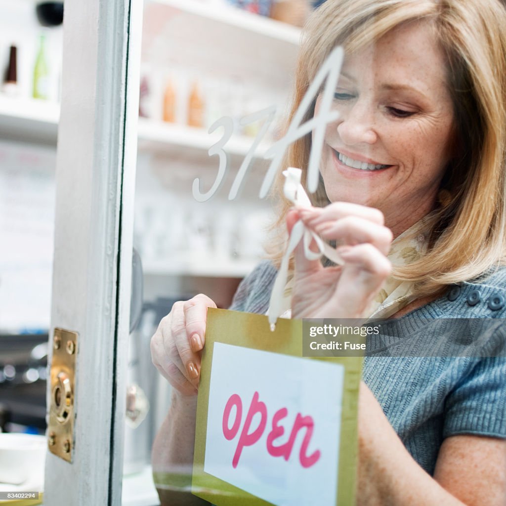 Woman Attaching Sign to Door