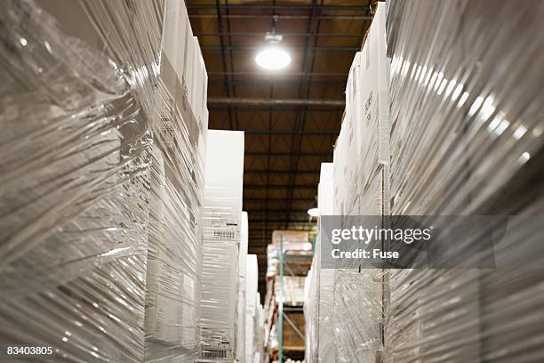 boxes wrapped in plastic in warehouse - fuse box stock-fotos und bilder