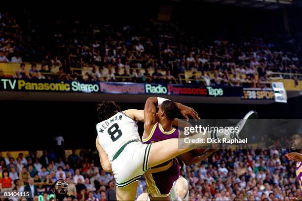Scott Wedman of the Boston Celtics climbs on the back of Byron Scott of the Los Angeles Lakers as they battle for a rebound during Game Six of the...