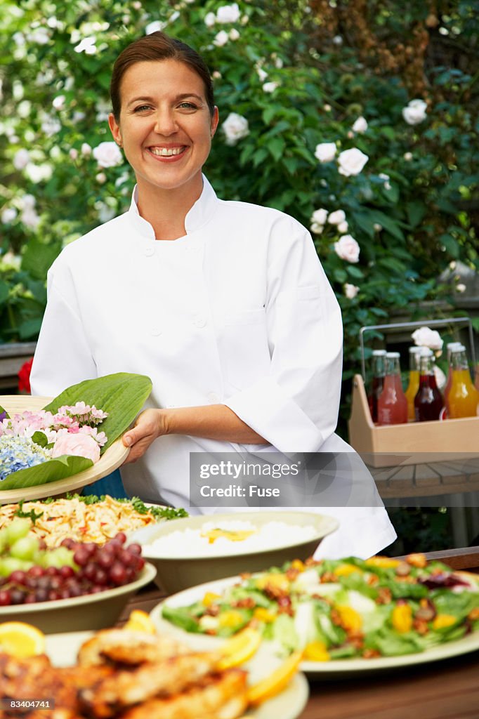 Woman Serving Outdoor Meal